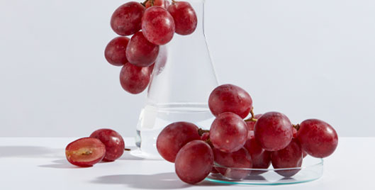 Image of grapes with science lab containers