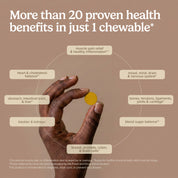 Yellow CuraMed® chewable tablet held between fingers